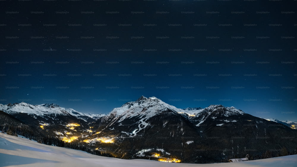 a snowy mountain range at night