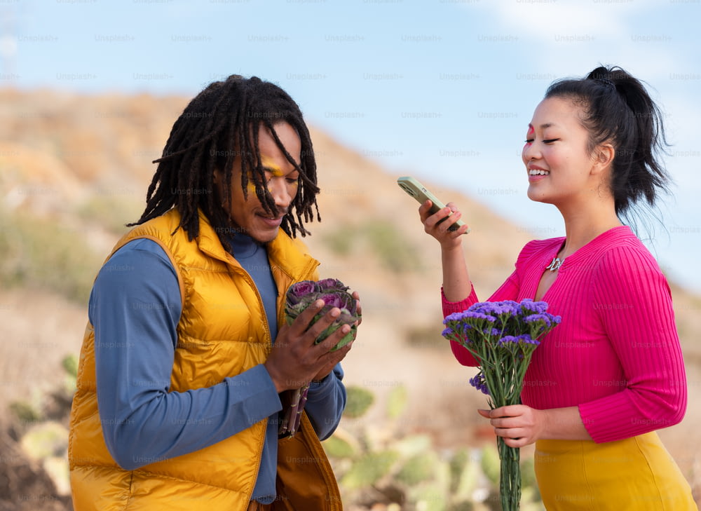a person holding flowers and a cell phone next to a person holding flowers