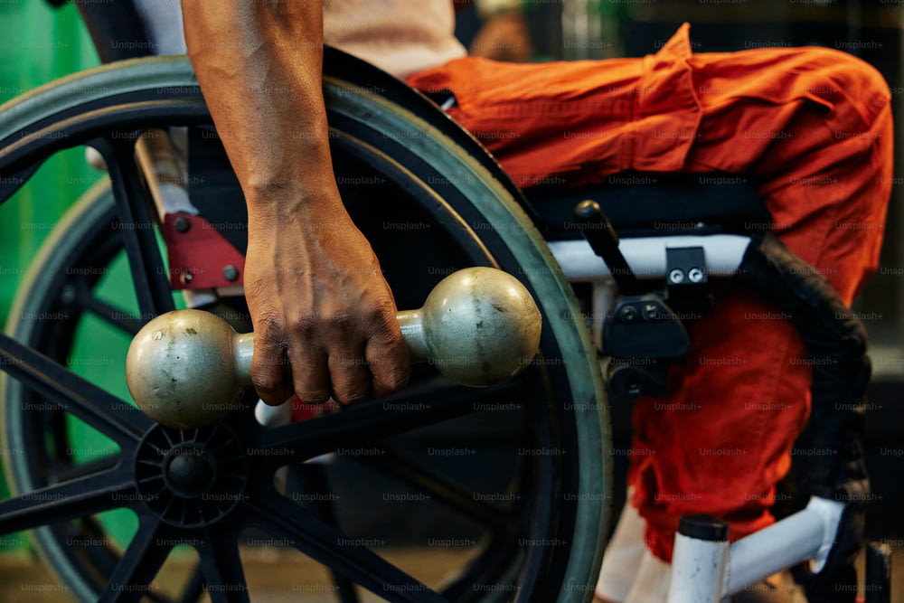 a close up of a person pushing a wheel chair