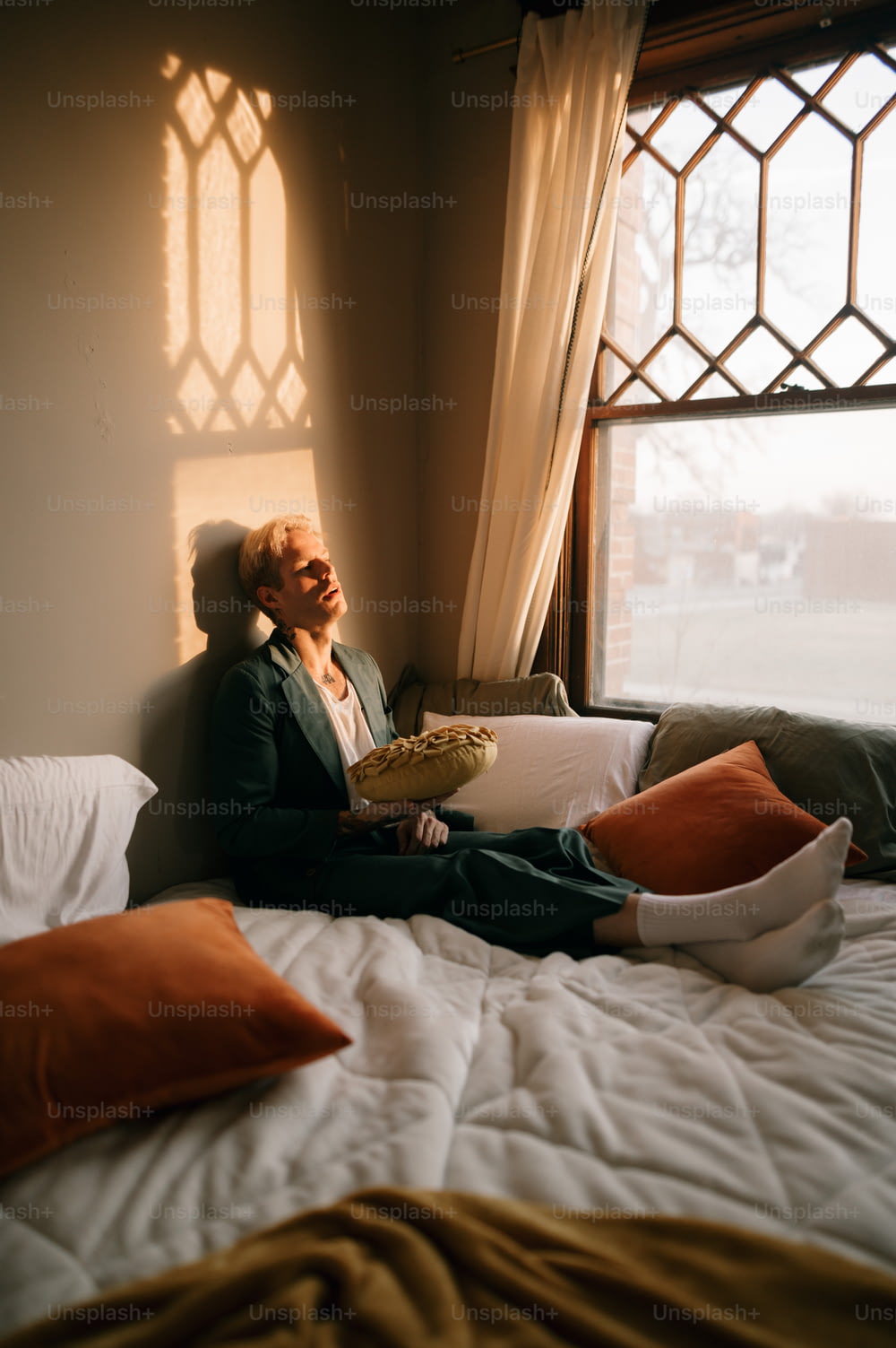 a person sitting on a bed reading a book