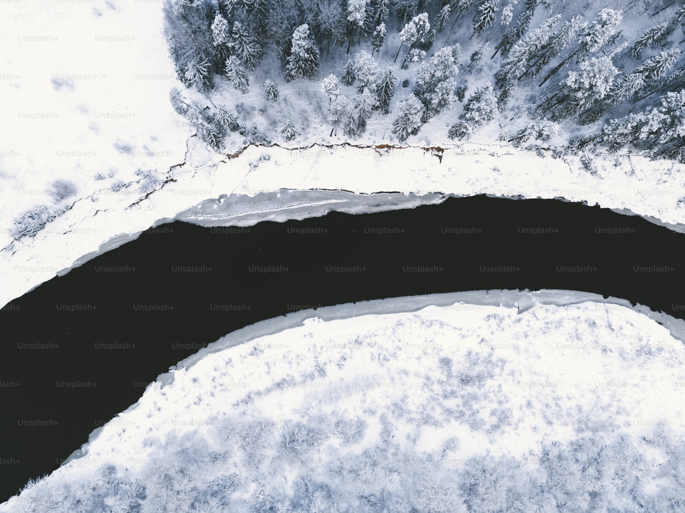 an aerial view of a snow covered lake