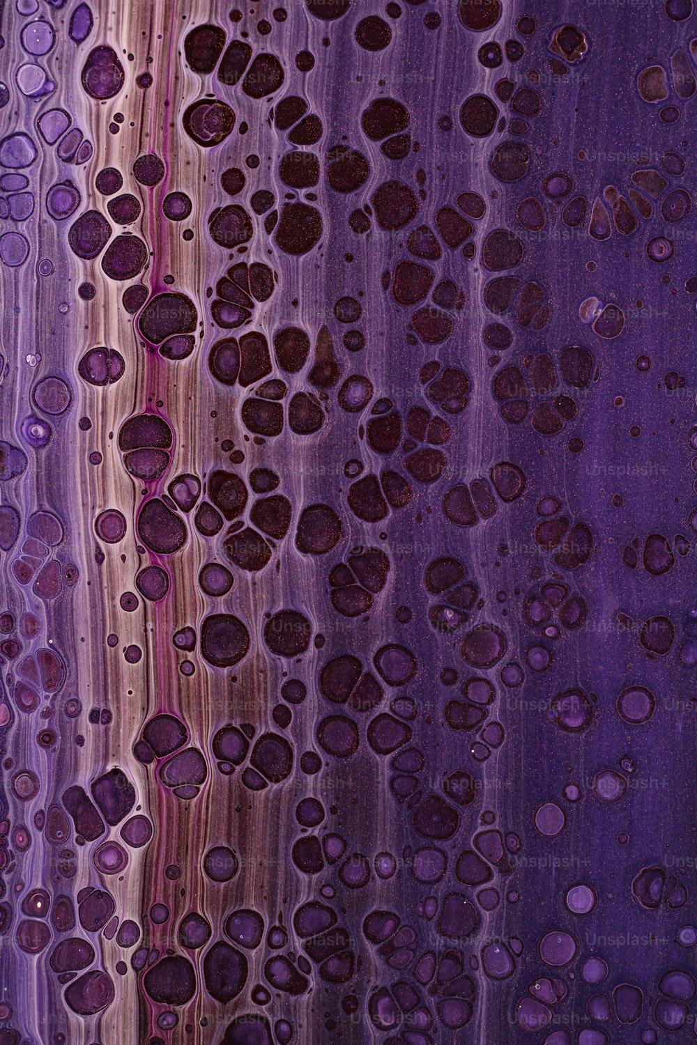 a close up of water drops on a purple surface