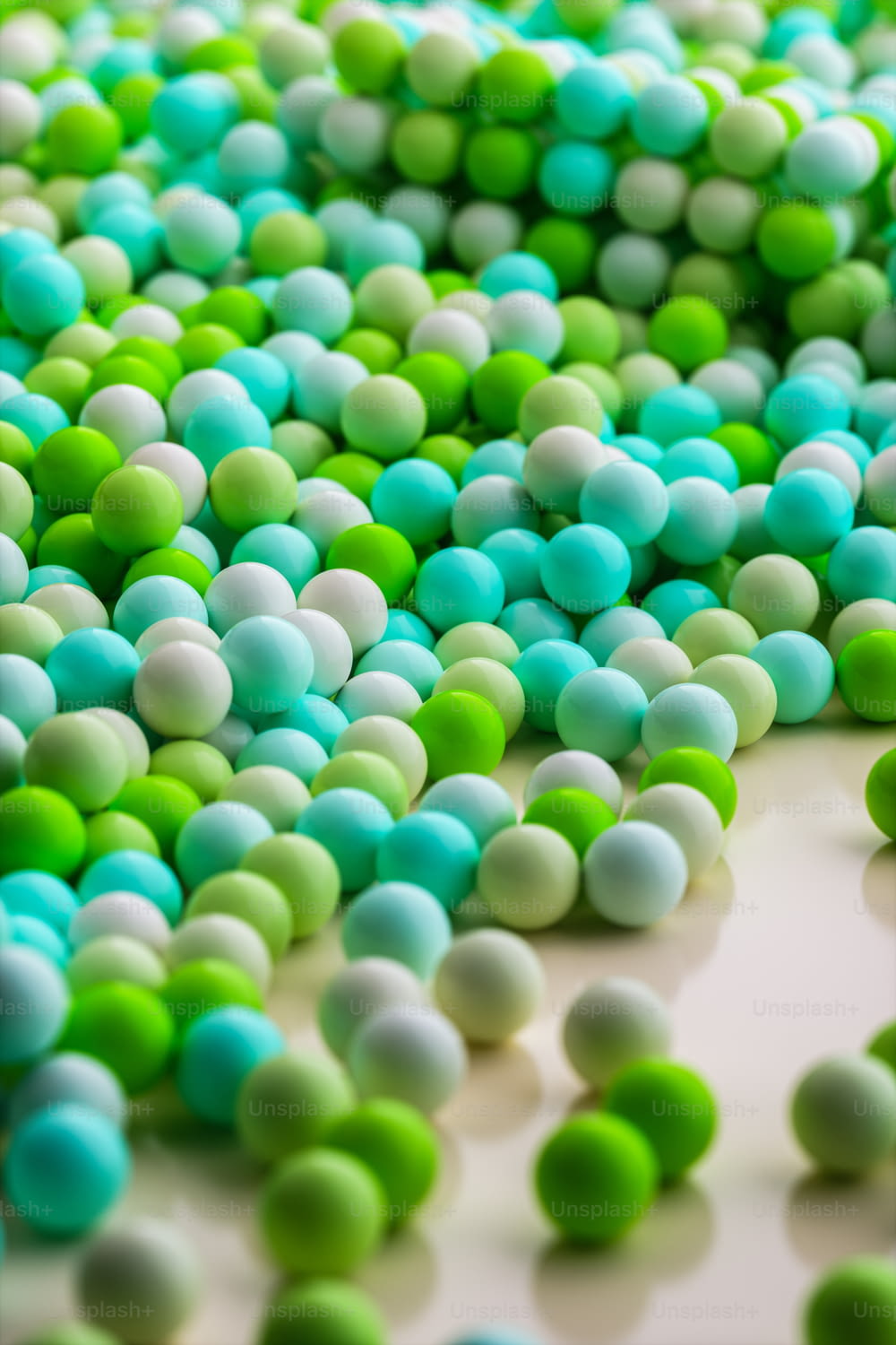 a bunch of green and white balls on a table