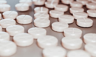 a close up of many white pills on a table
