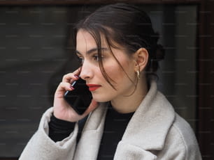 a woman is talking on a cell phone