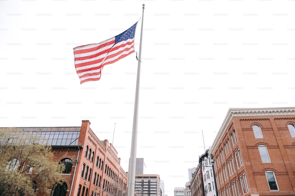 a large american flag is flying in the air