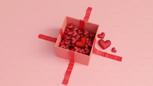 Une boîte rose remplie de beaucoup de cœurs rouges