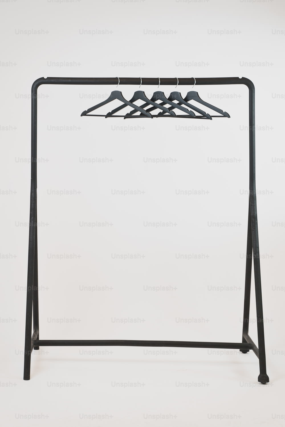 a clothes rack with four hangers on it