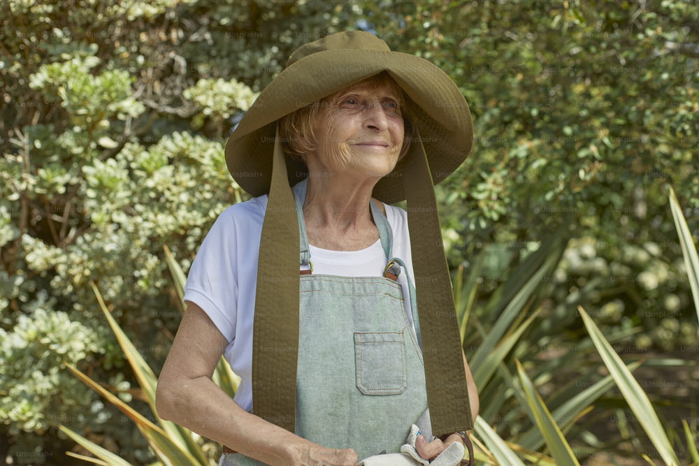 an older woman wearing a green hat and apron