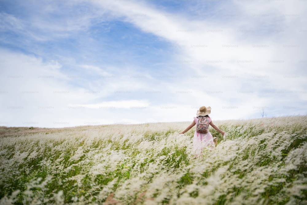 female tourist, she freely walks on the meadow.