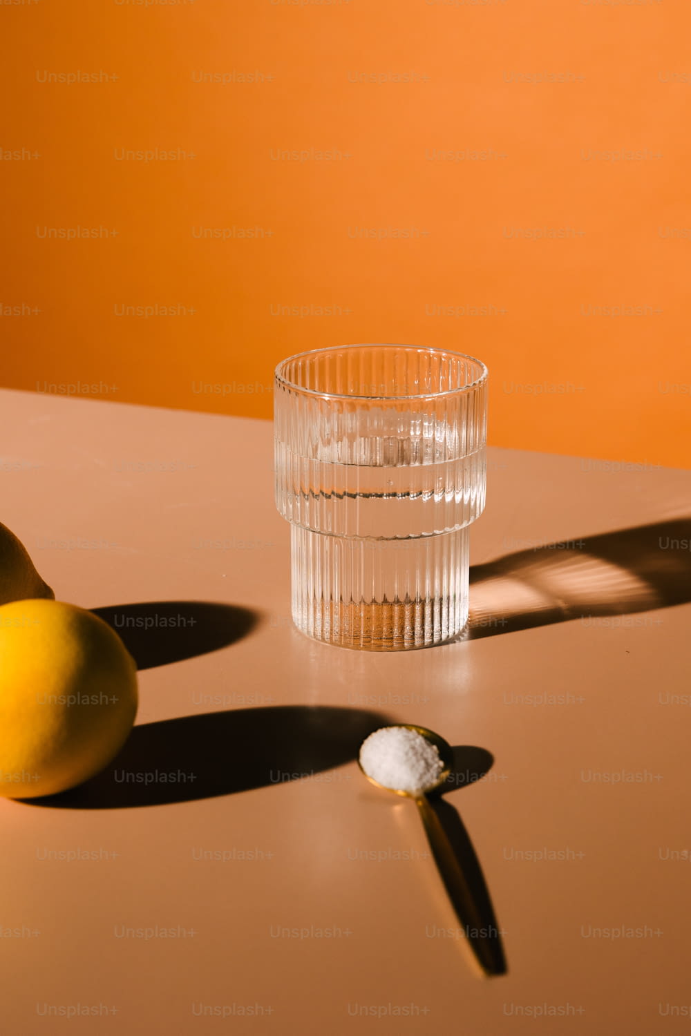two lemons and a glass on a table