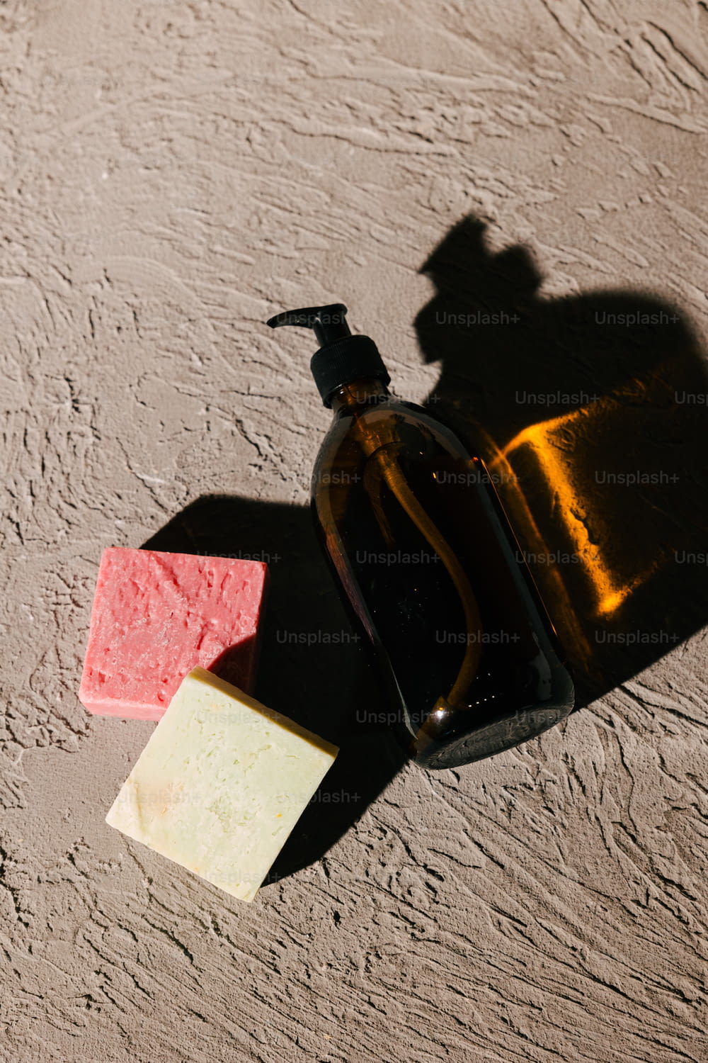 a bottle of soap next to a soap bar