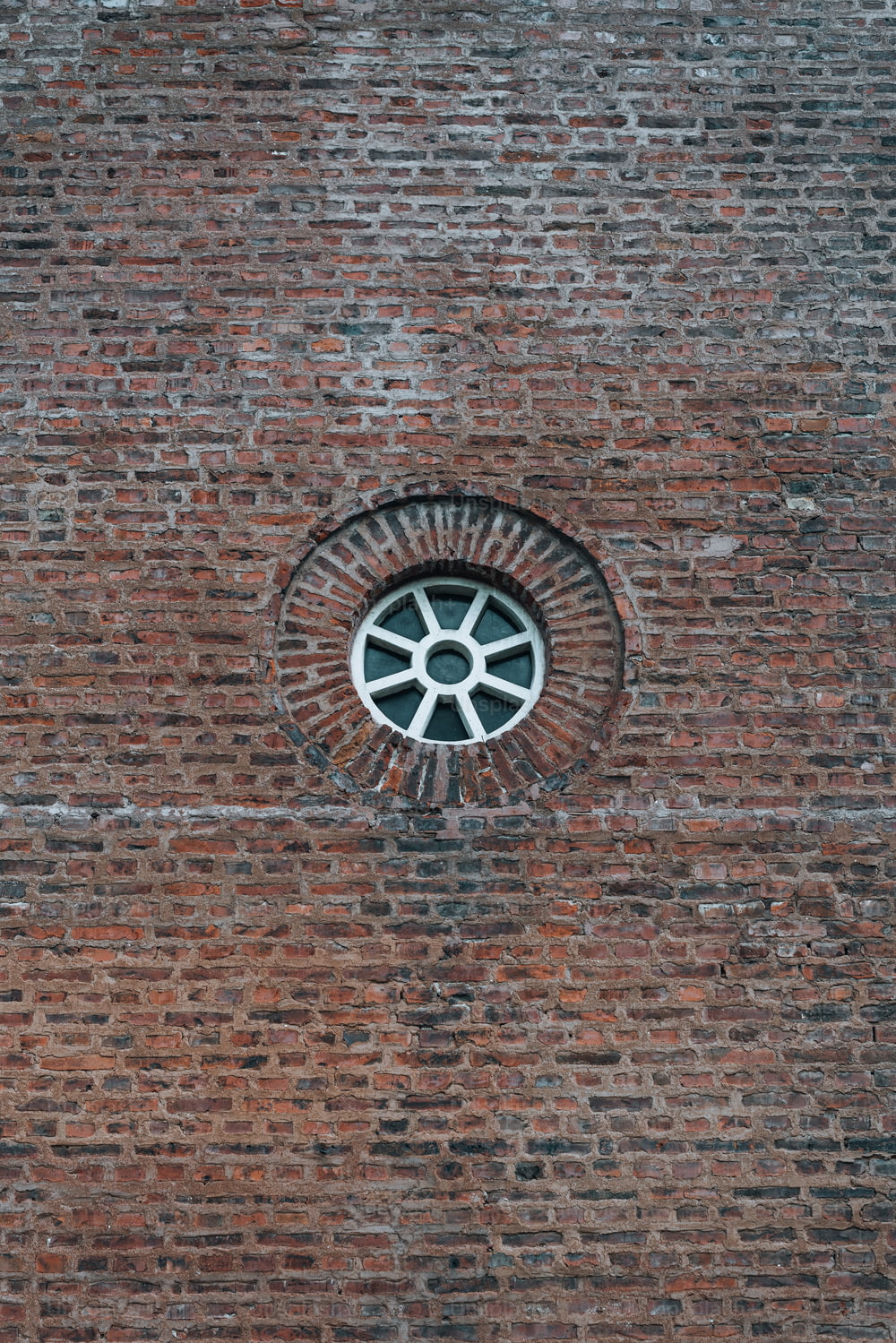 a round window in a brick wall