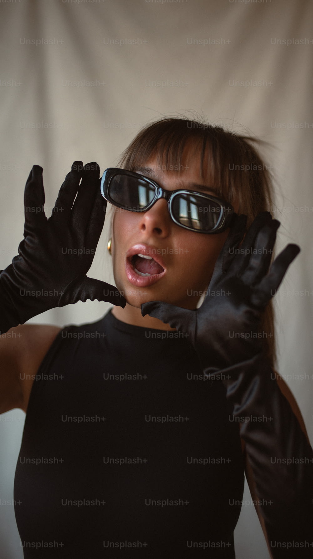 a woman wearing black gloves and a pair of 3d glasses