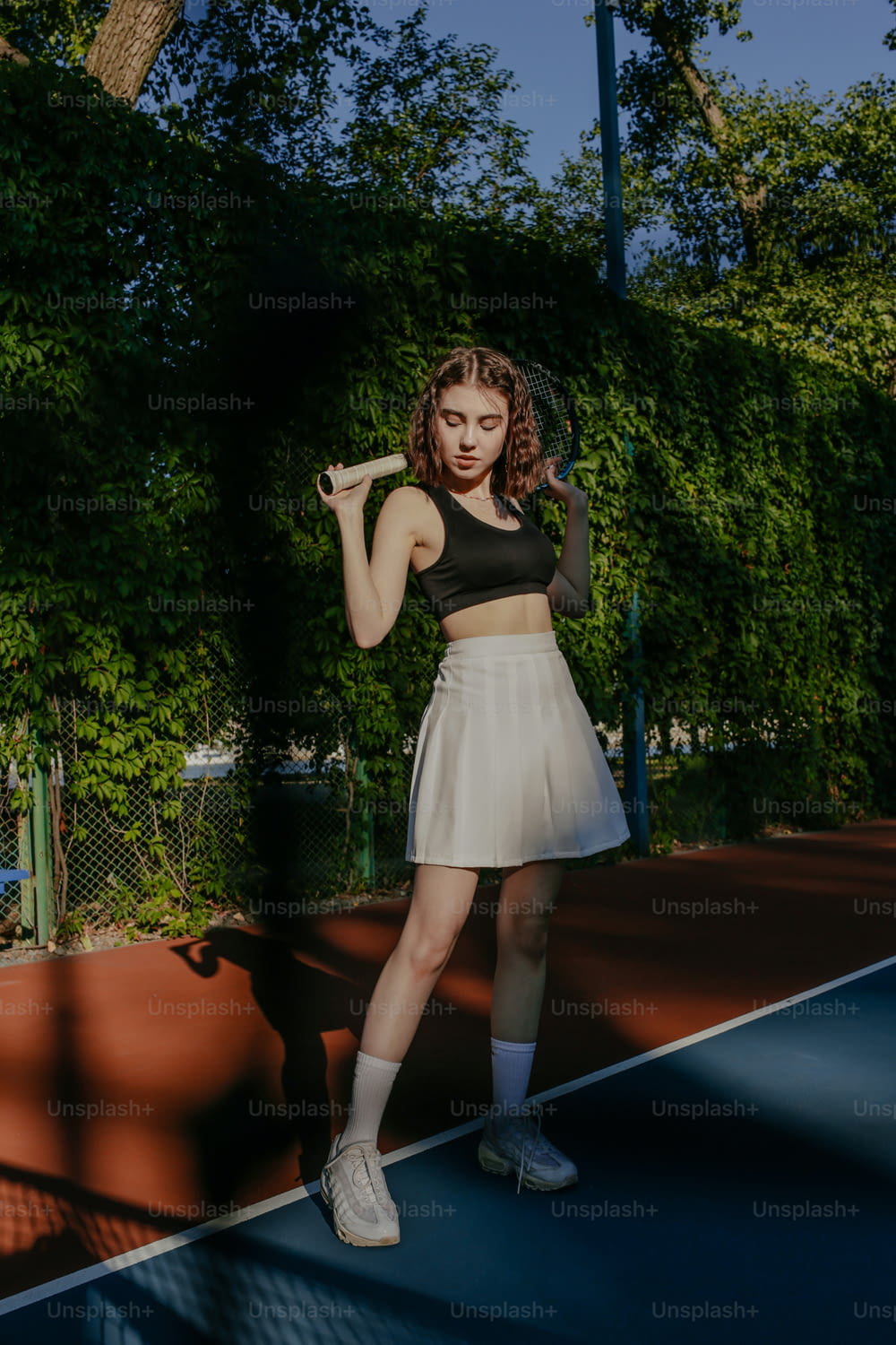 a woman standing on a tennis court holding a racquet