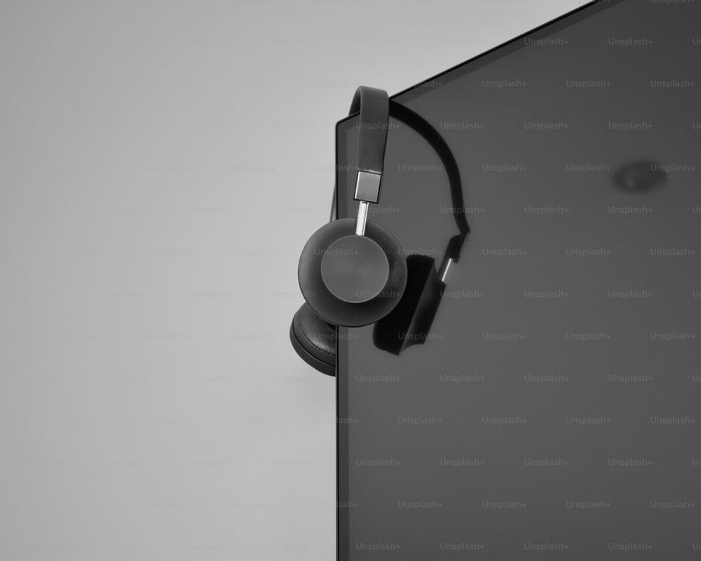 a pair of headphones hanging from the side of a wall