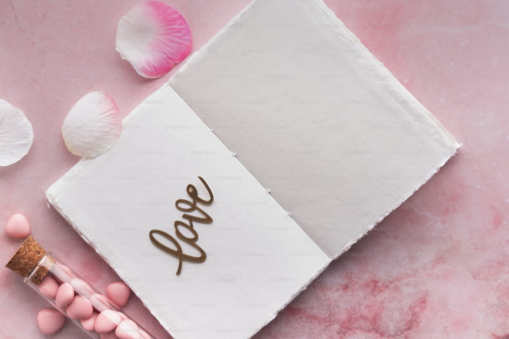 a notepad with the word love written on it next to some candy