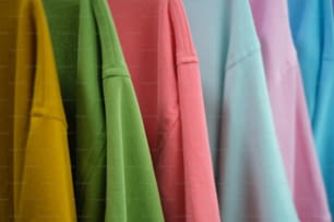 a row of colorful shirts hanging on a rack