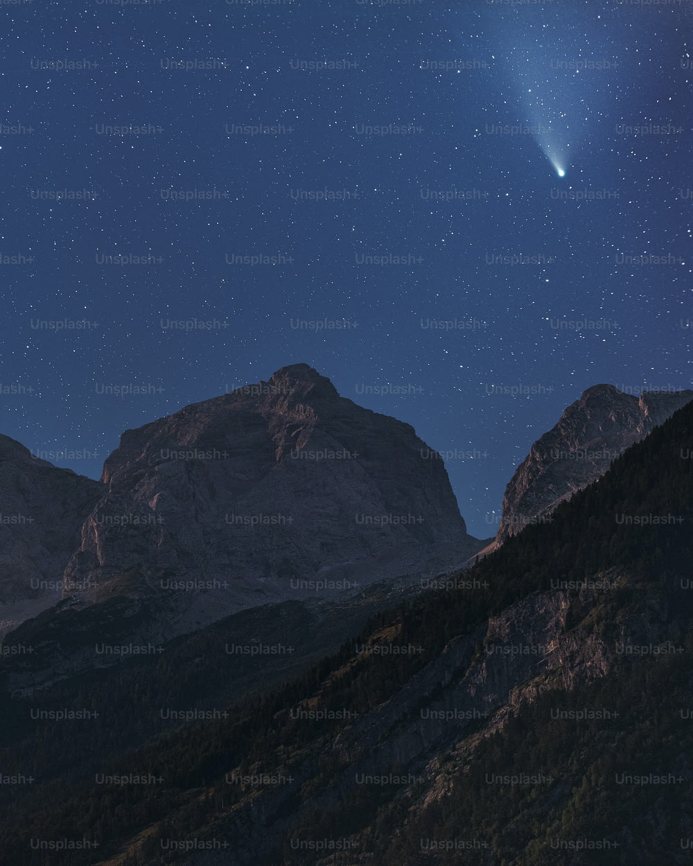 a view of a mountain with a bright star in the sky