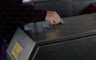 a person pressing a button on a microwave
