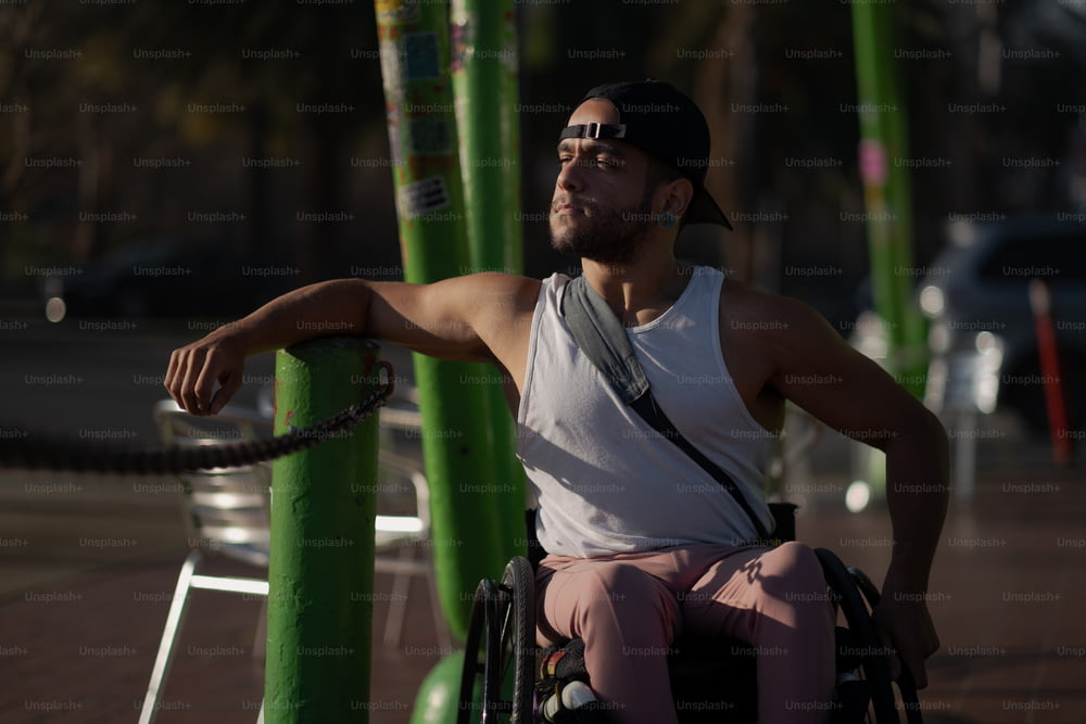 a man in a wheel chair on a sidewalk