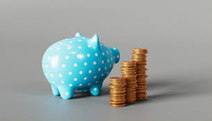 a blue piggy bank next to stacks of coins