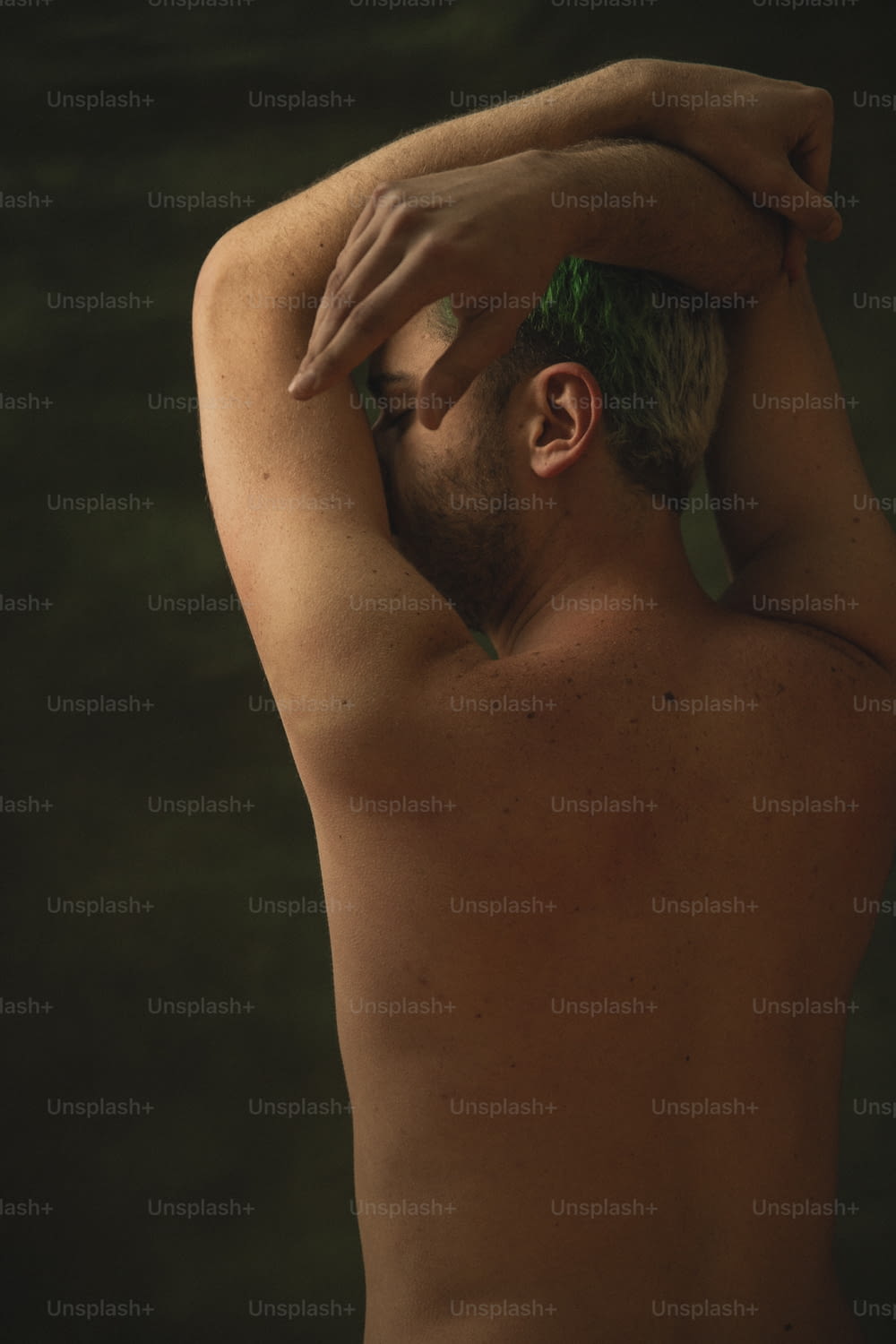 a shirtless man with green hair and no shirt on