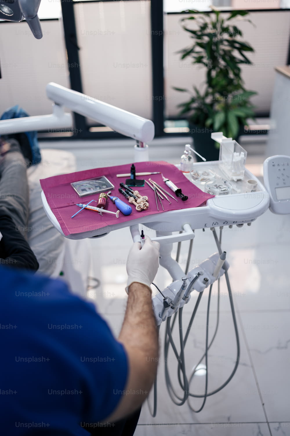 a man is sitting in a dentist chair with tools on it