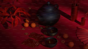 a tea pot, a tea cup, and some oranges on a table