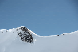 a snowboarder is jumping off of a snowy mountain