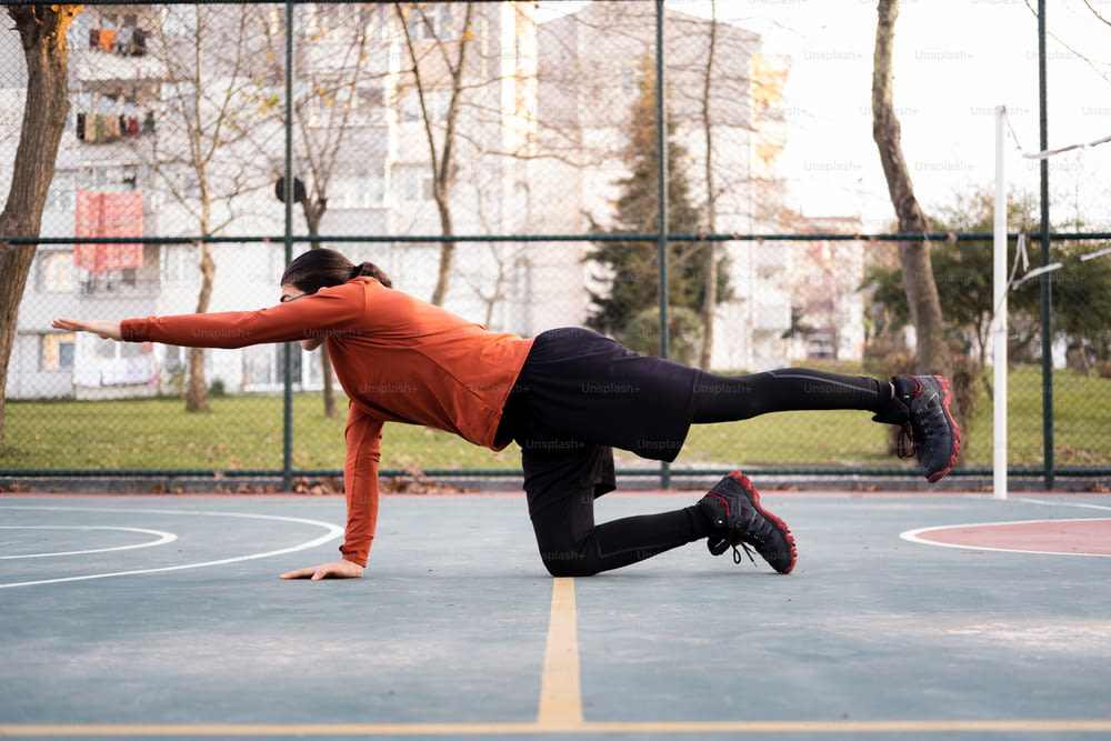 a man is doing a handstand on a basketball court