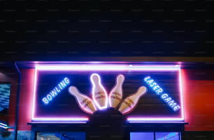 a neon sign for bowling with two bowling pins on it