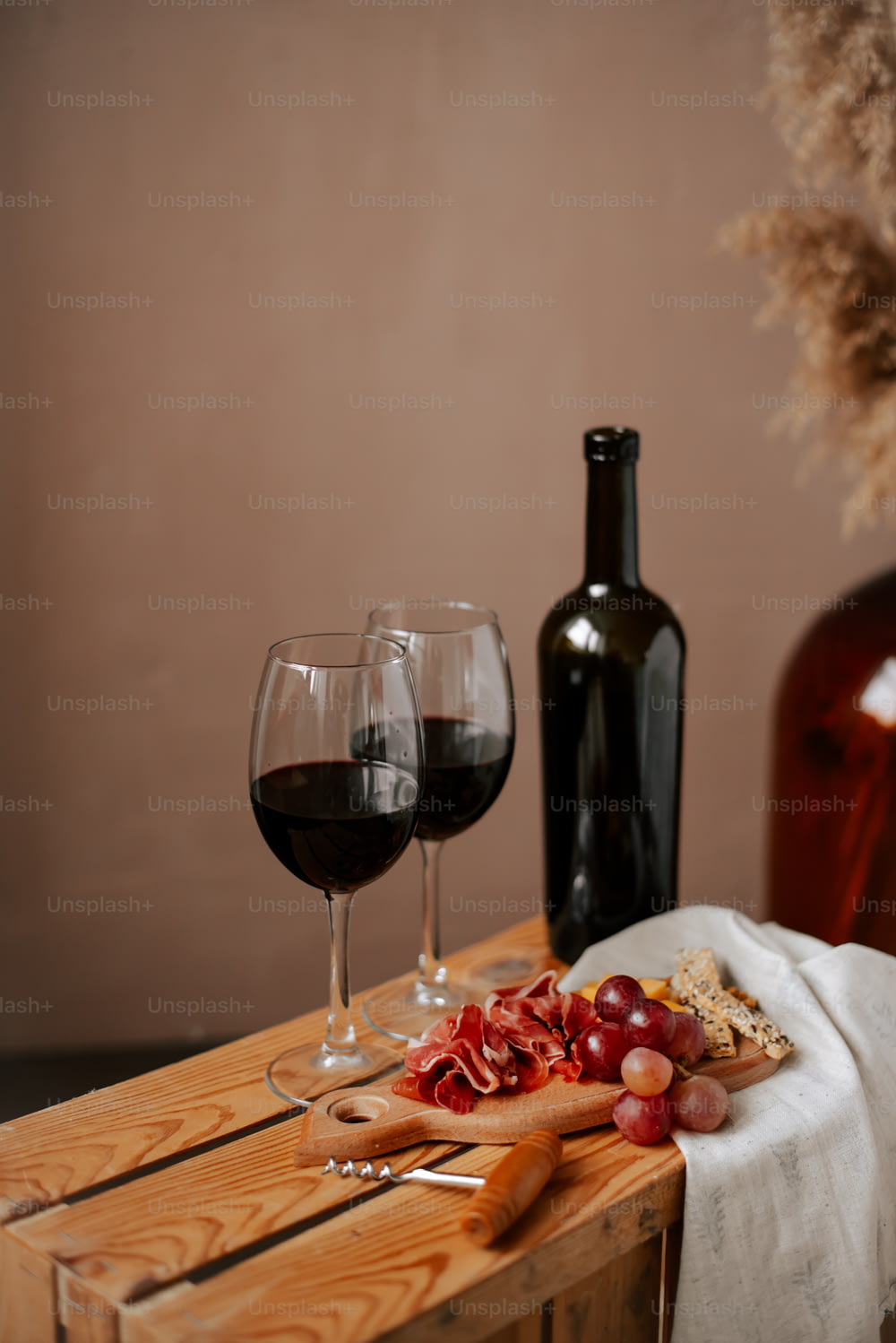 a wooden table topped with two glasses of wine