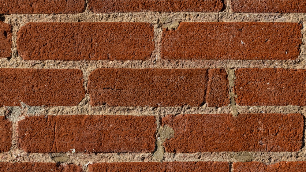 a close up of a brick wall made of red bricks