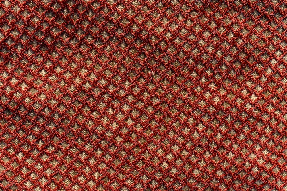 a close up of a red and black checkered tie
