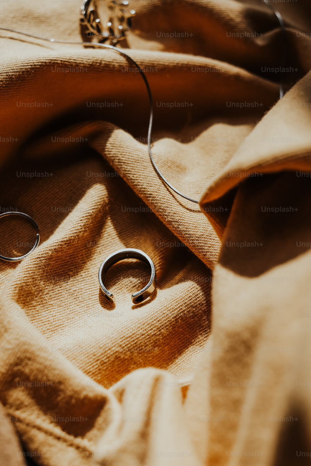 a pair of silver rings sitting on top of a blanket
