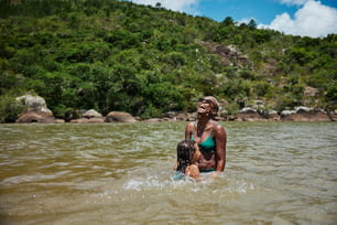 a woman in a bikini standing in a body of water