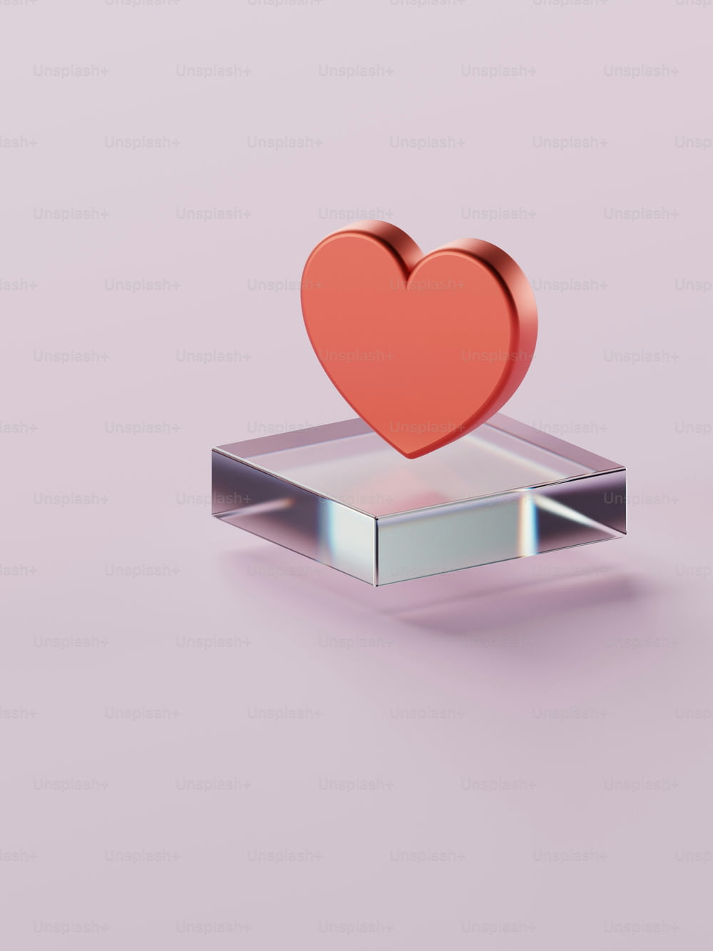 a red heart sitting on top of a metal object