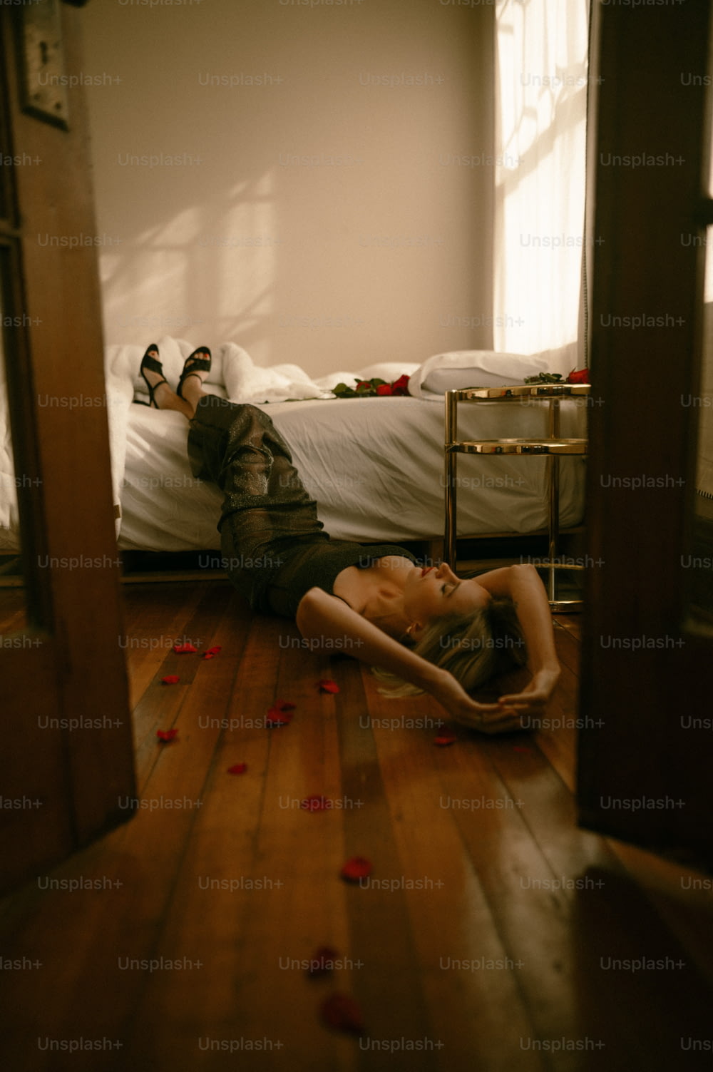 a woman laying on the floor in a bedroom