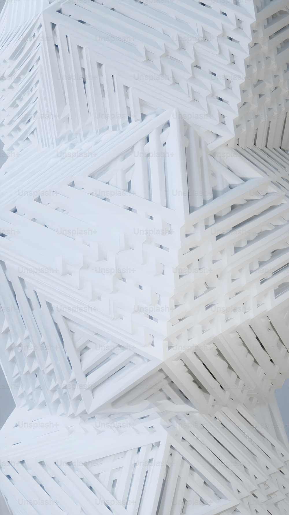 a large white sculpture with many lines on it