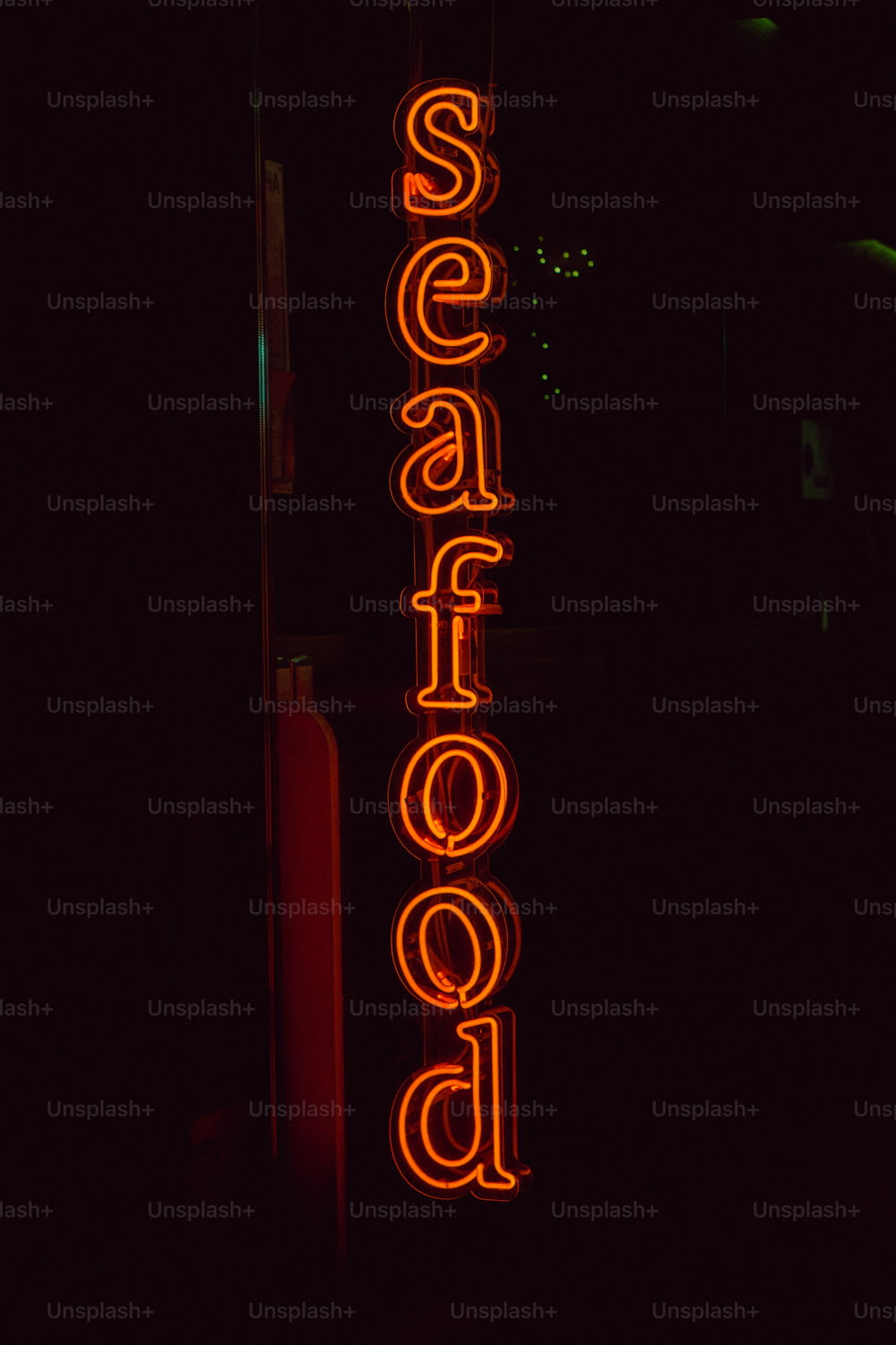 a neon sign that says seafood on it