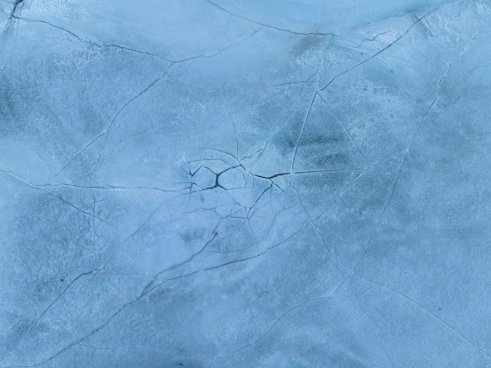 a snow covered ground with cracks in it