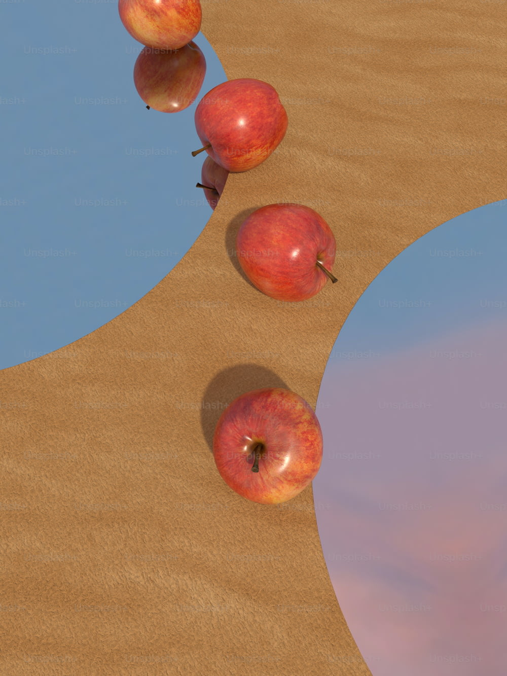 a group of apples sitting on top of a sandy beach