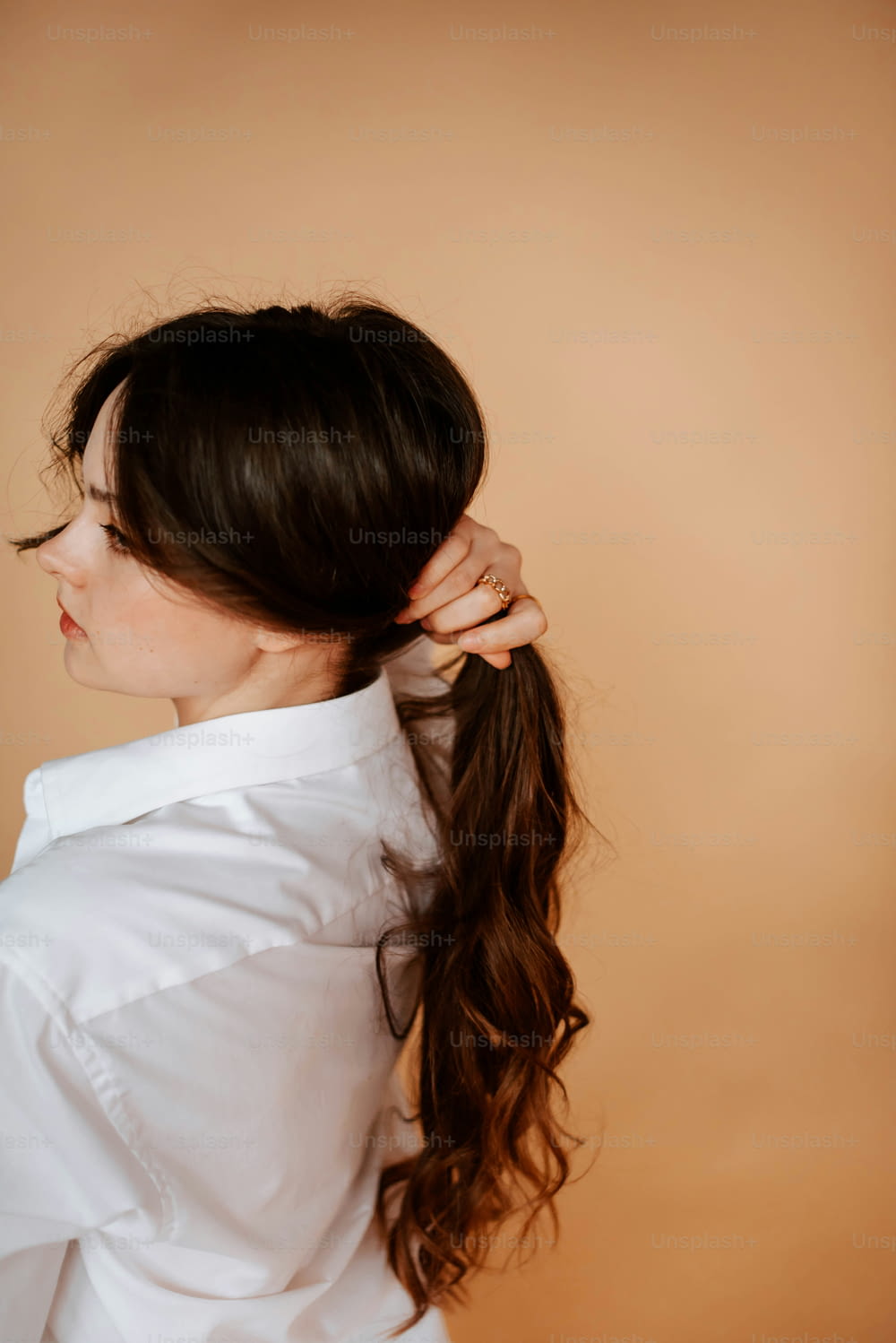a woman with long hair in a ponytail