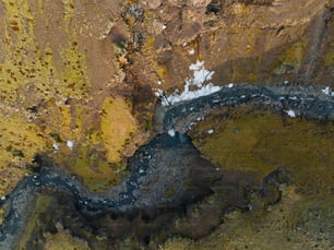 an aerial view of a river in a rocky area