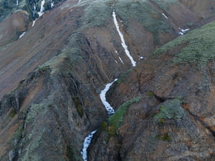 a view of a mountain with a stream running through it