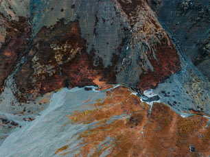 an aerial view of a mountain with a river running through it