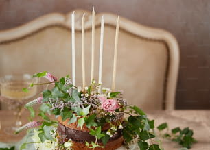 a cake decorated with flowers and candles on a table