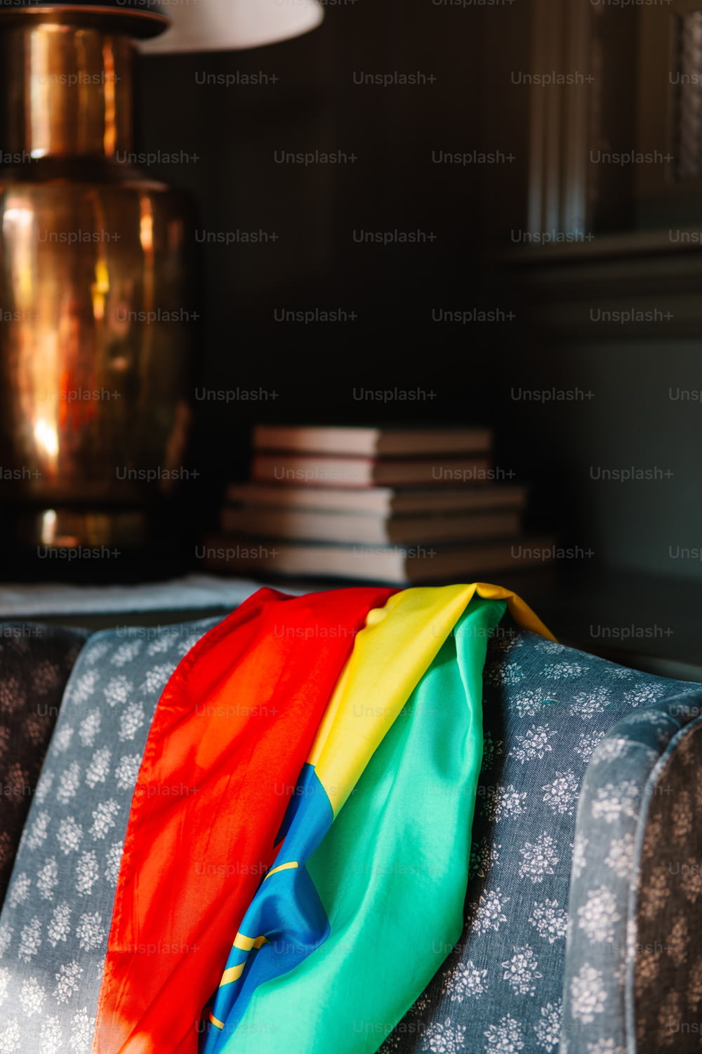 a rainbow colored scarf on a couch in a living room