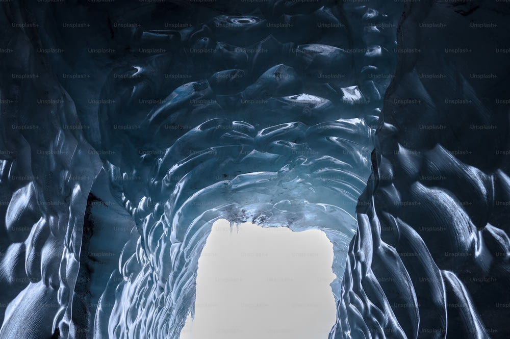 a large ice cave with water flowing down it